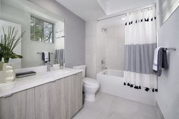 A bathroom with a toilet sink and bathtub